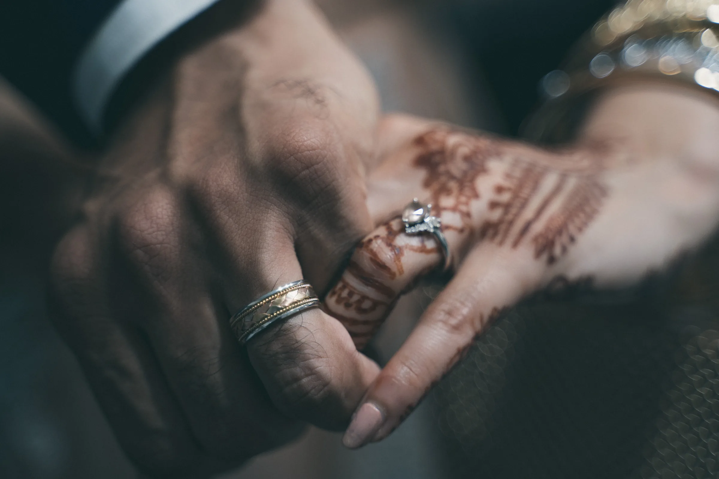 Close view of the bride's henna-adorned hands and wedding jewelry